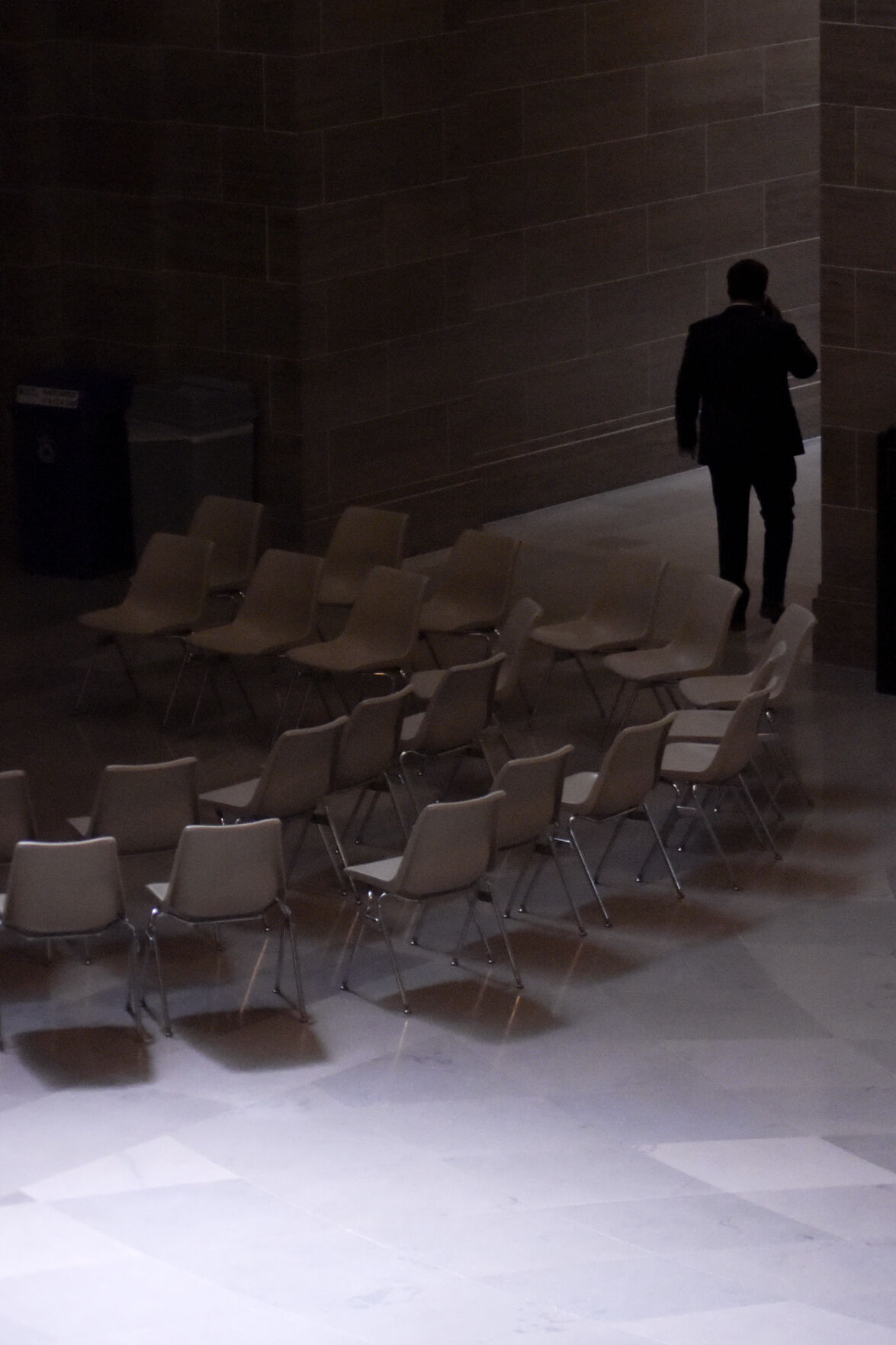 An official walks past a group of chairs